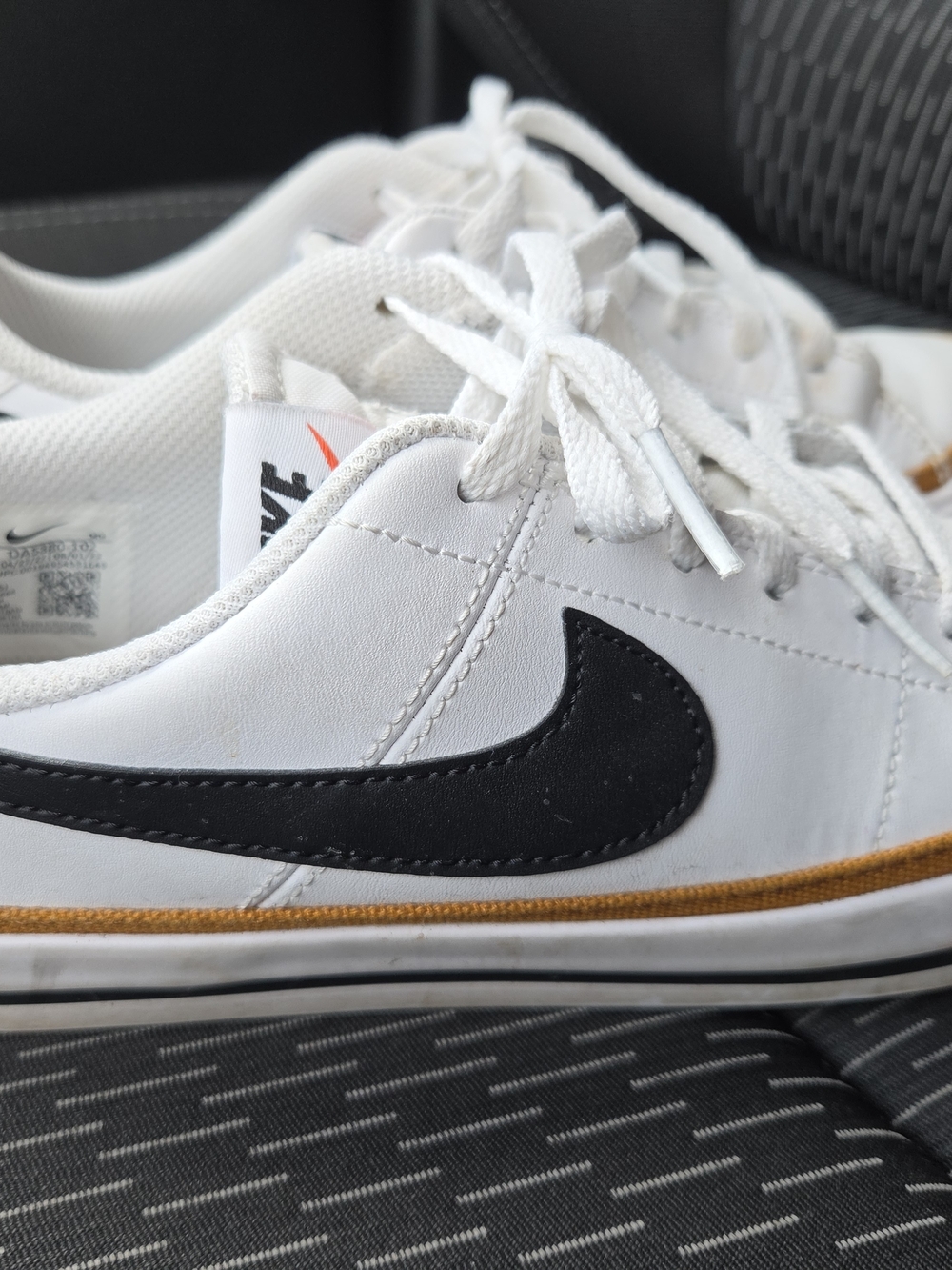 Nike Kids White Sneakers with Black Swoosh and Gold Accent